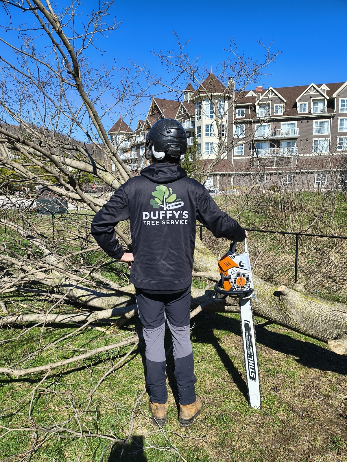Duffy's Tree Service branded sweater featuring company logo